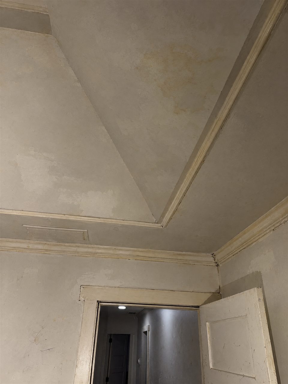Tray ceiling with stains and yellowed trim