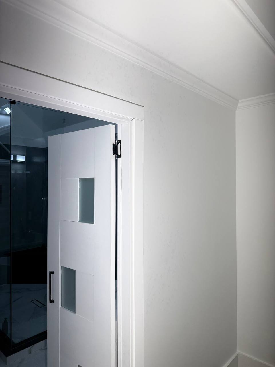 White door trim and crown molding with crisp paint lines